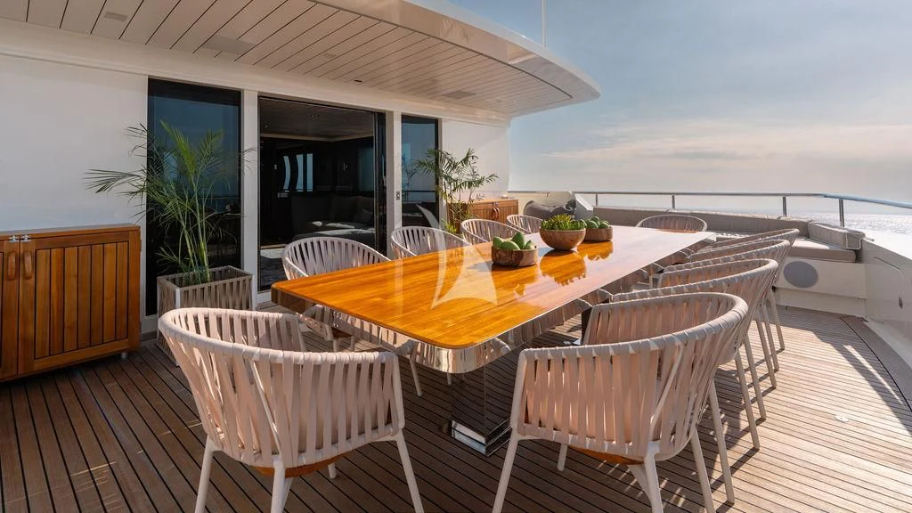 a table and chairs outside aboard GALILEO Yacht for Sale