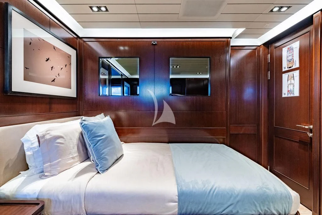 a room with a bed and a mirror aboard GALILEO Yacht for Sale