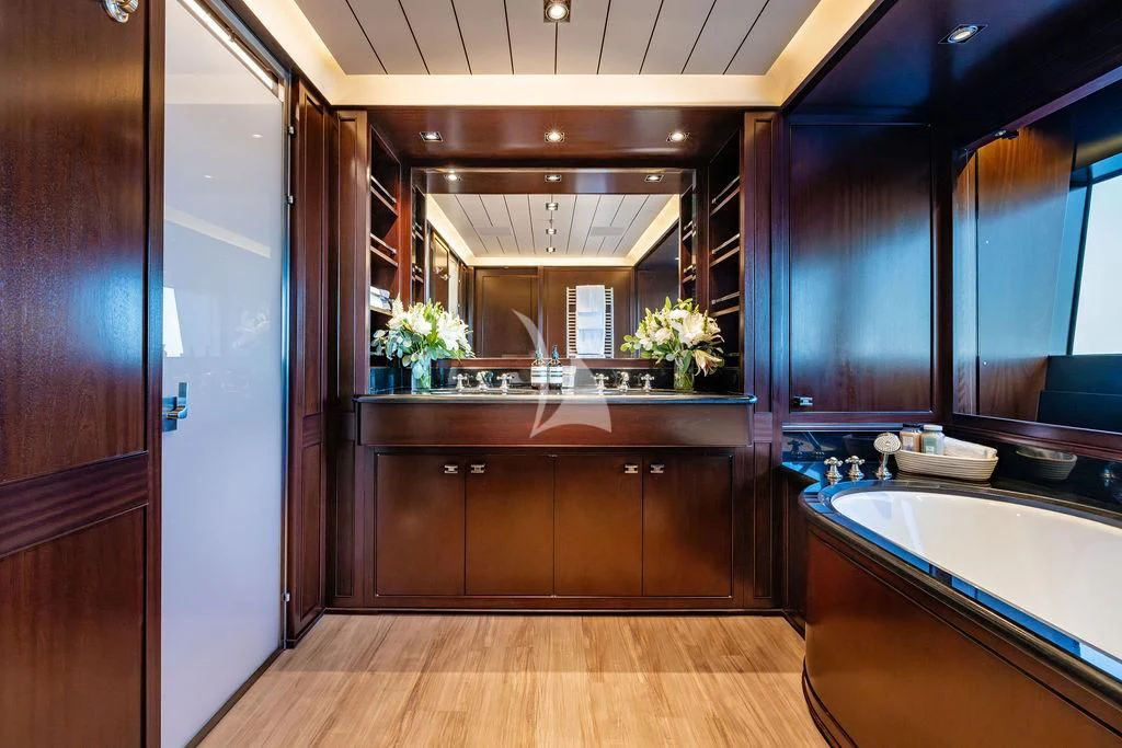 a bathroom with a tub sink and cabinets aboard GALILEO Yacht for Sale