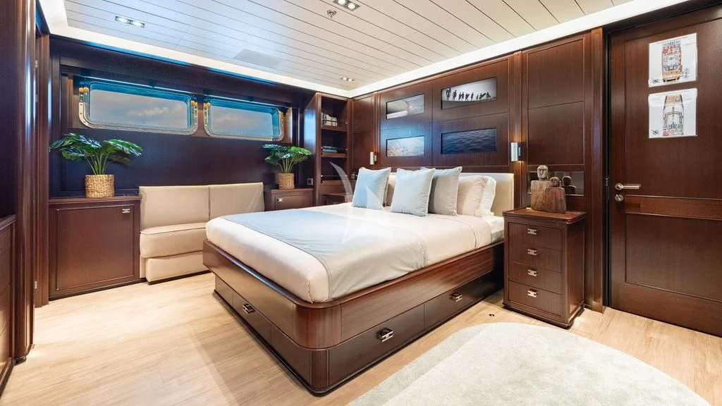 a room with a bed and a couch aboard GALILEO Yacht for Sale