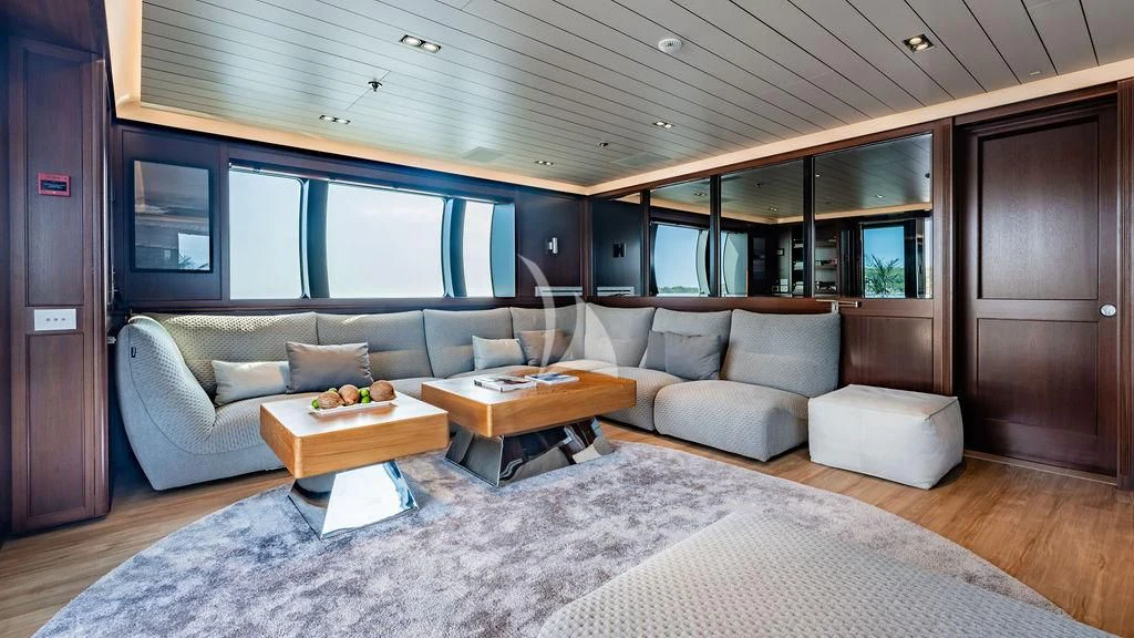 a living room with a couch and a coffee table aboard GALILEO Yacht for Sale
