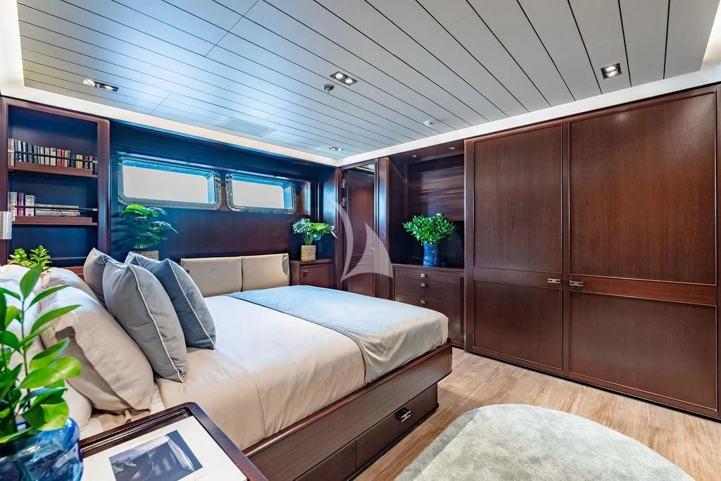 a room with a bed and a desk aboard GALILEO Yacht for Sale