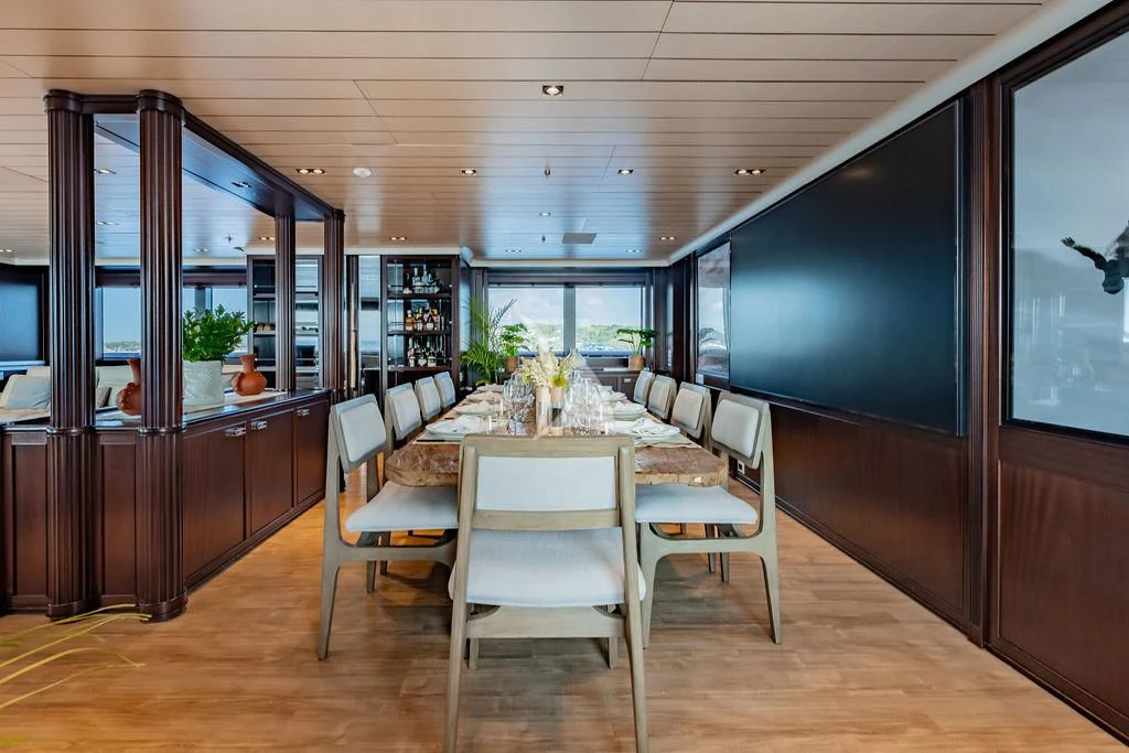 a room with a table chairs and a large window aboard GALILEO Yacht for Sale