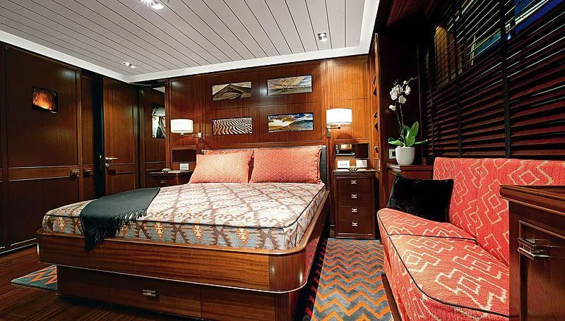 a bedroom with a bed and a couch aboard GALILEO Yacht for Sale