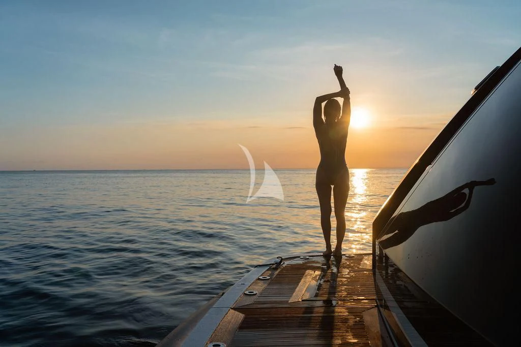 a person standing on a dock with their feet up in the air aboard GALILEO Yacht for Sale