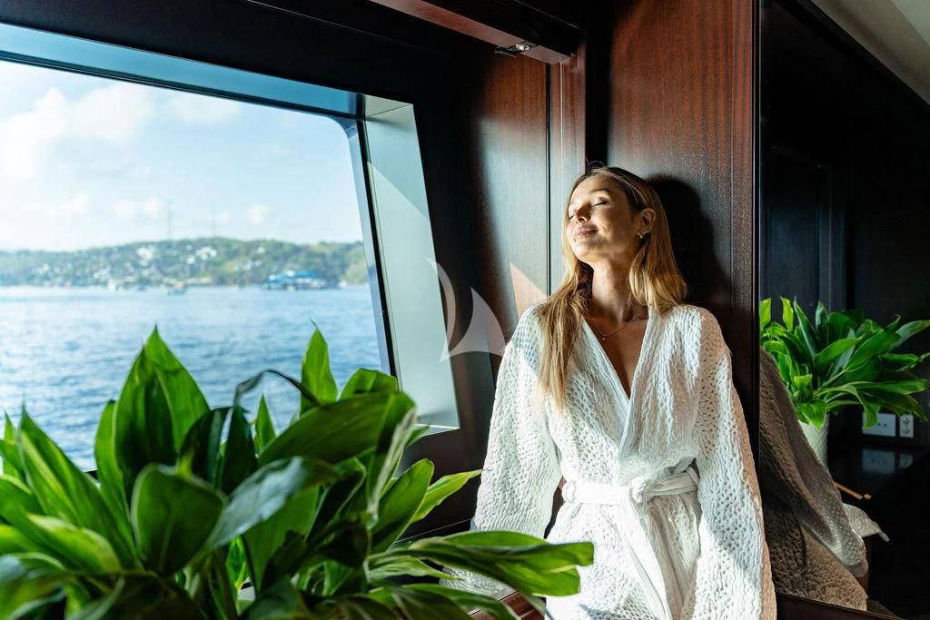 a woman sitting in a window aboard GALILEO Yacht for Sale