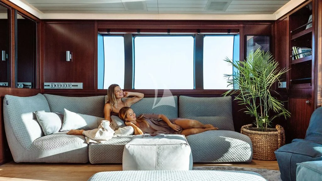 a person and a child on a couch aboard GALILEO Yacht for Sale
