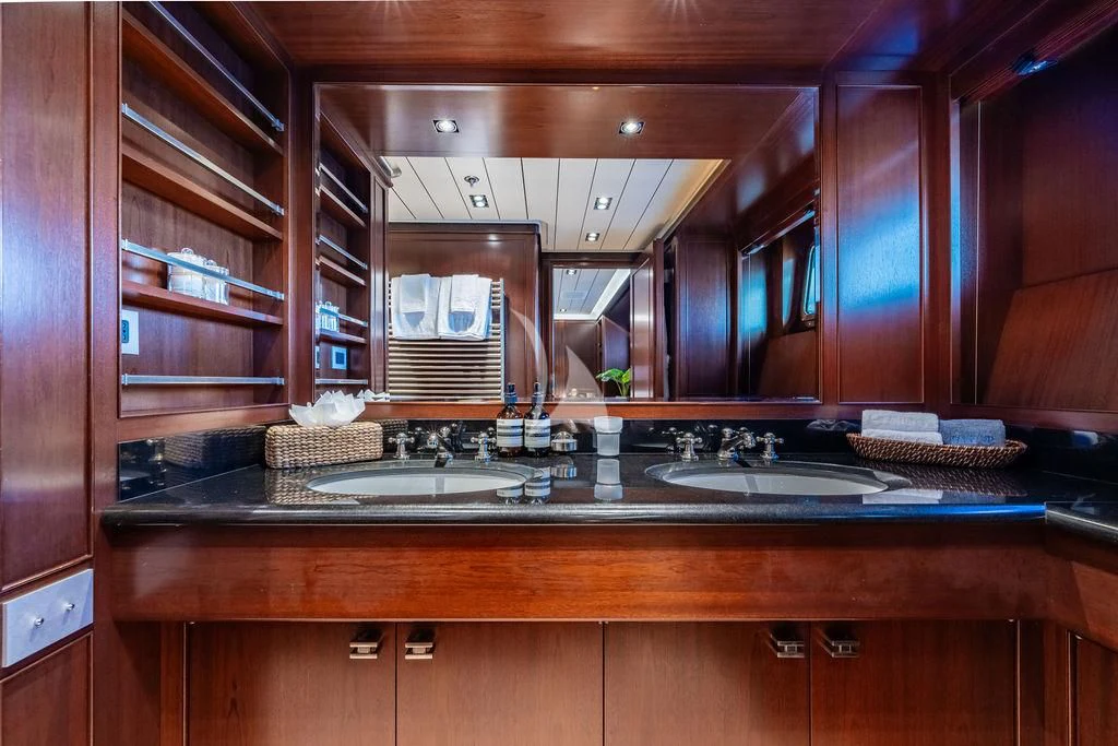 a kitchen with wooden cabinets aboard GALILEO Yacht for Sale