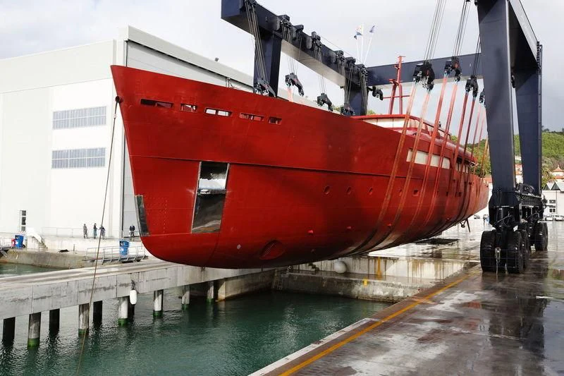 a large red boat on a dock aboard GALILEO Yacht for Sale