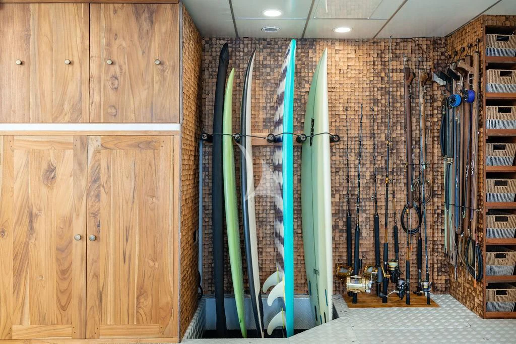 a room with a wall of lockers and a rack of surfboards aboard GALILEO Yacht for Sale