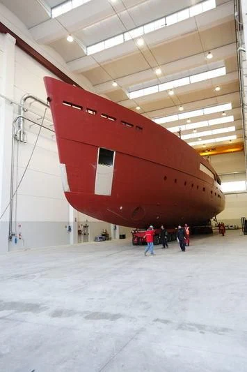 a large red helicopter in a hangar aboard GALILEO Yacht for Sale