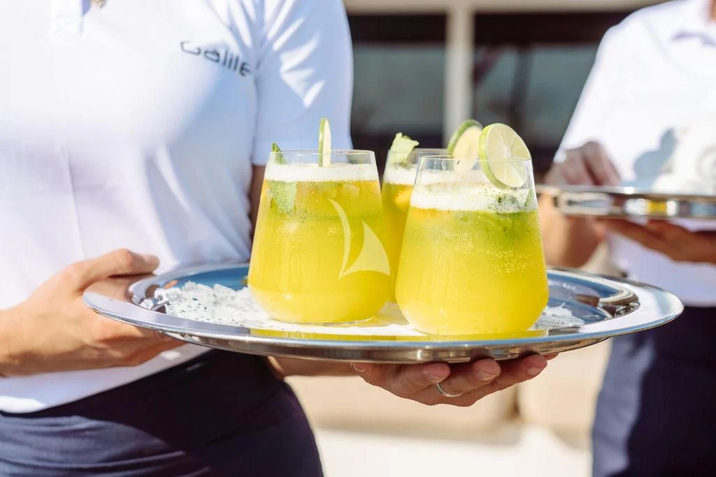 a person holding a plate of food aboard GALILEO Yacht for Sale