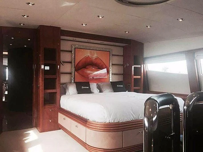 a bedroom with a bed and a desk aboard NATALIA Yacht for Sale