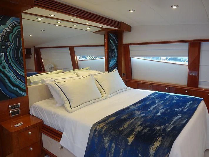 a bed with blue sheets aboard NATALIA Yacht for Sale