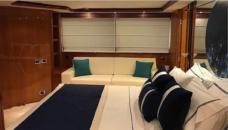 a room with a bed and a wood cabinet aboard NATALIA Yacht for Sale