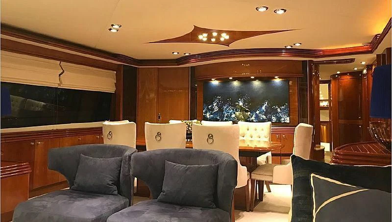a living room with a couch and a tv aboard NATALIA Yacht for Sale