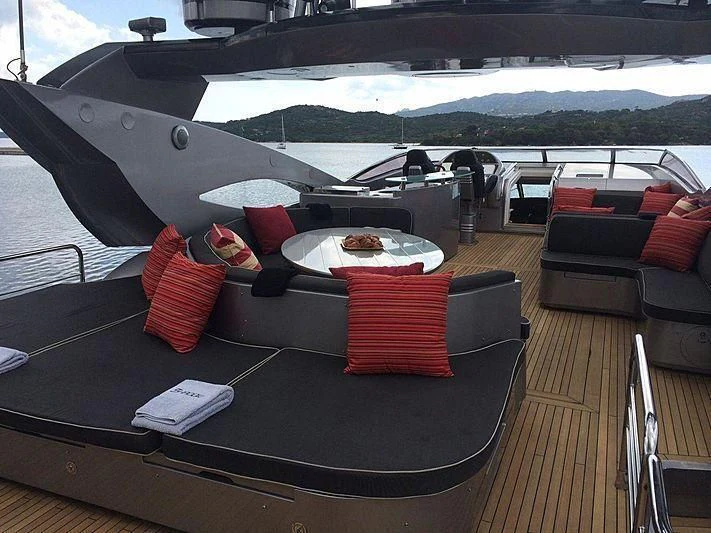 a deck with a table and chairs aboard NATALIA Yacht for Sale