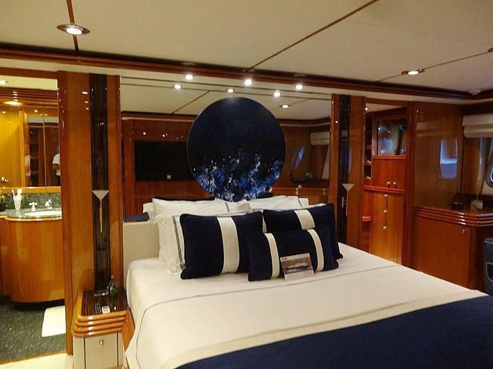 a bed with a large black dog on the head aboard NATALIA Yacht for Sale