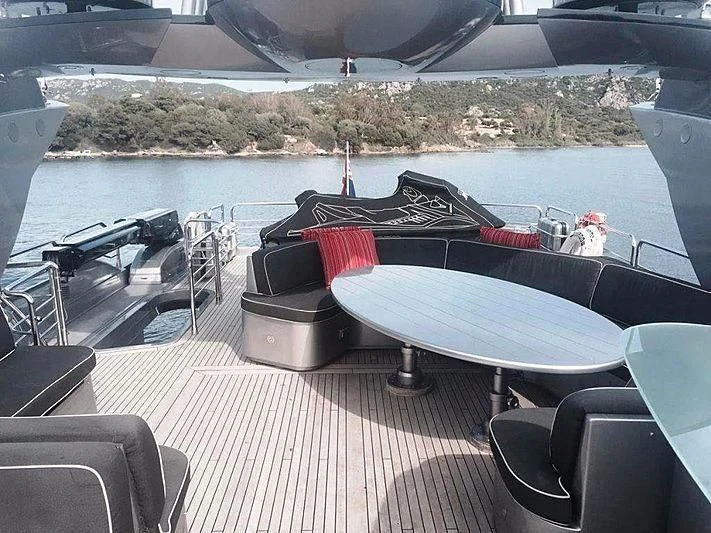 a deck with a table and chairs on it aboard NATALIA Yacht for Sale