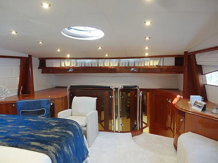 a room with a bed and desk aboard NATALIA Yacht for Sale