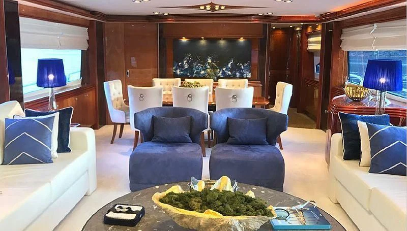 a living room with a large table and chairs aboard NATALIA Yacht for Sale
