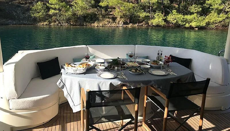 a table set for a meal on a boat aboard NATALIA Yacht for Sale