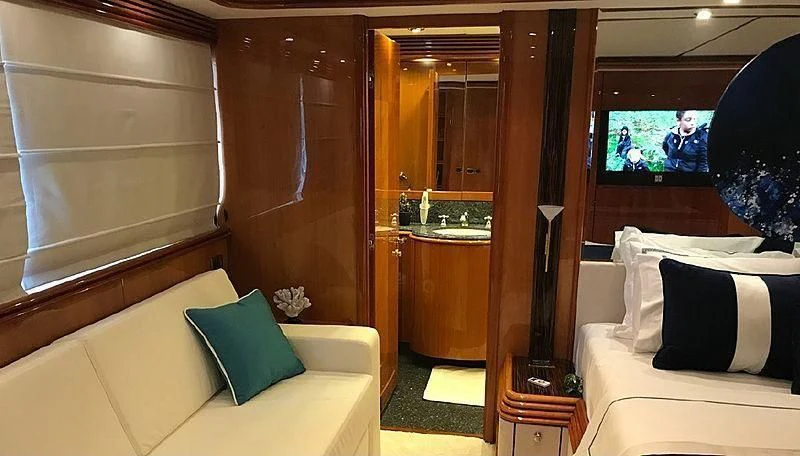 a room with a bed and a television aboard NATALIA Yacht for Sale