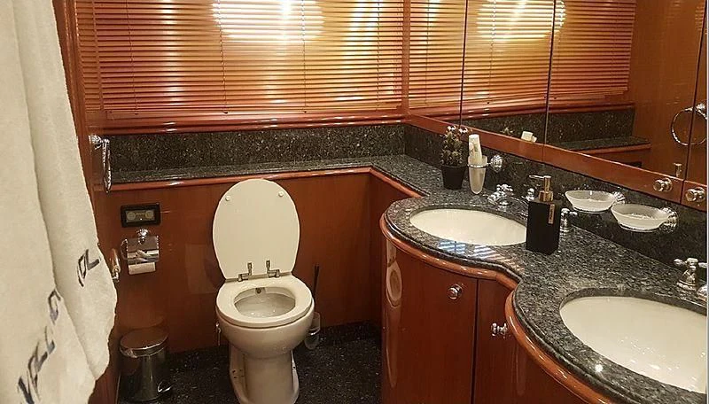 a bathroom with a sink toilet and a counter aboard NATALIA Yacht for Sale