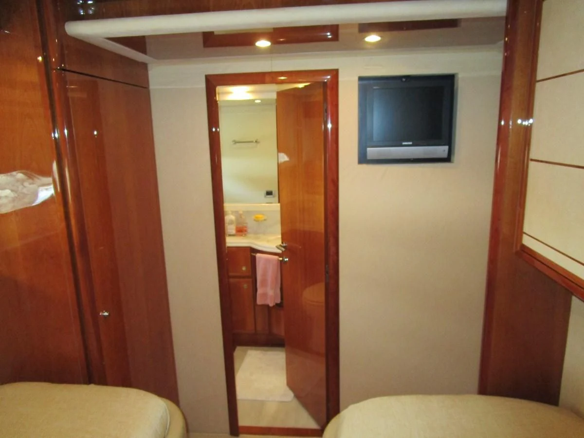 a bathroom with a tv on the wall aboard NACL Yacht for Sale