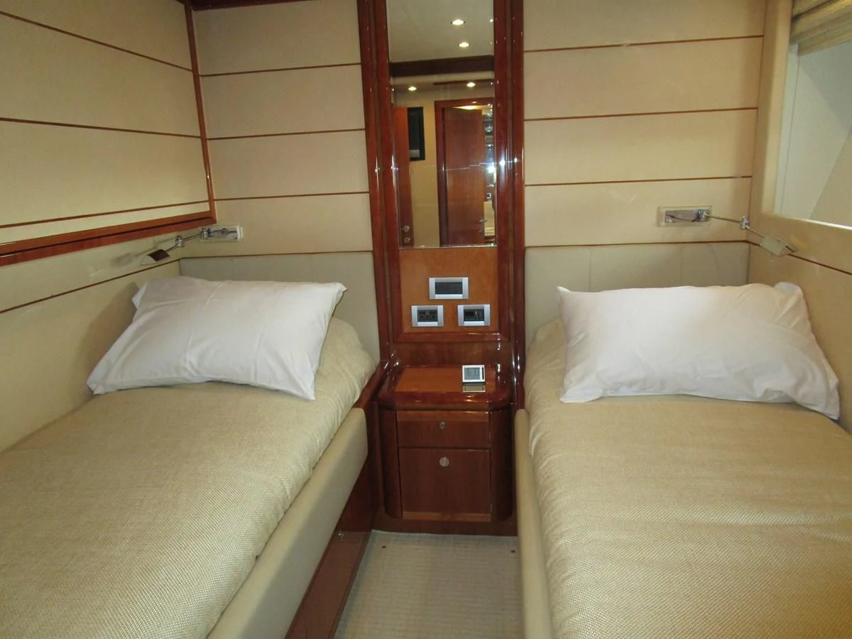 a room with two beds aboard NACL Yacht for Sale