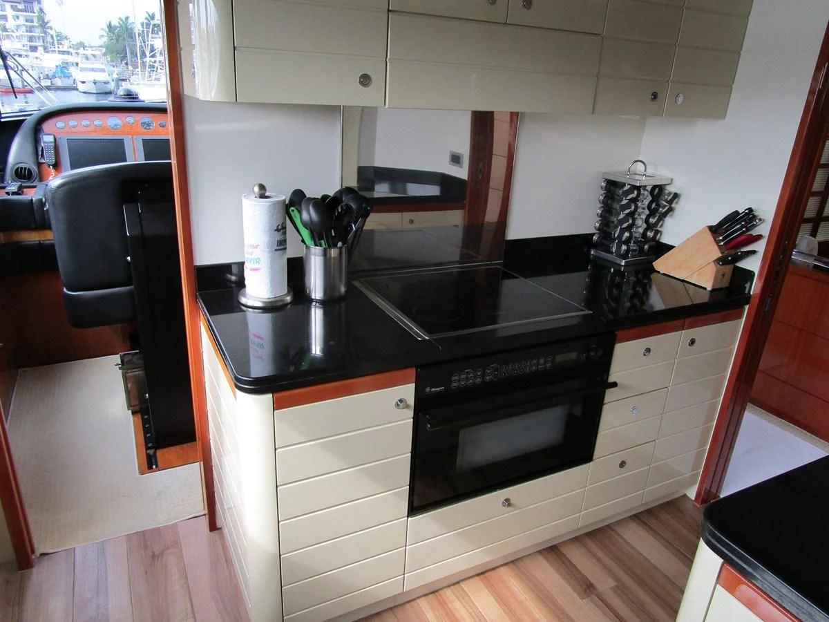 a kitchen with a stove and cabinets aboard NACL Yacht for Sale