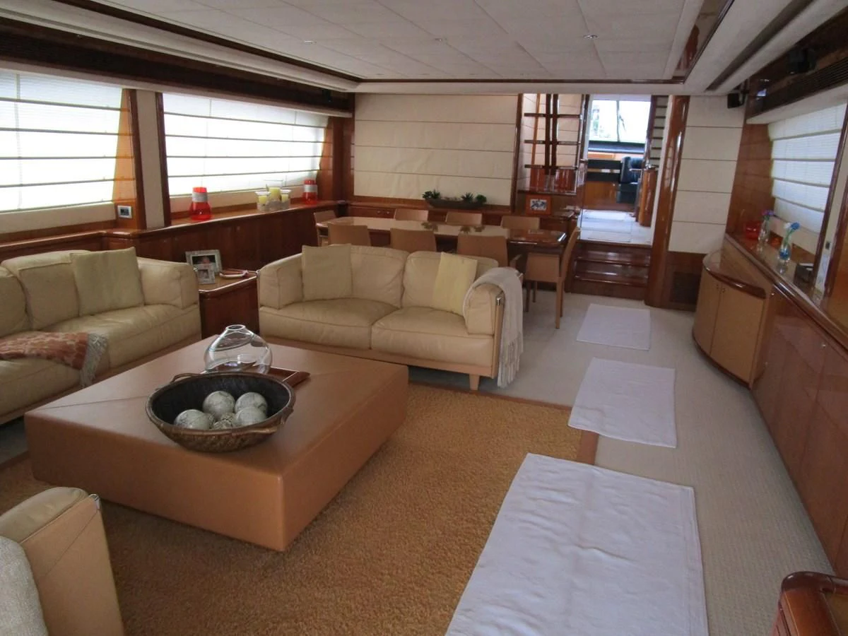 a living room with a couch and a table aboard NACL Yacht for Sale
