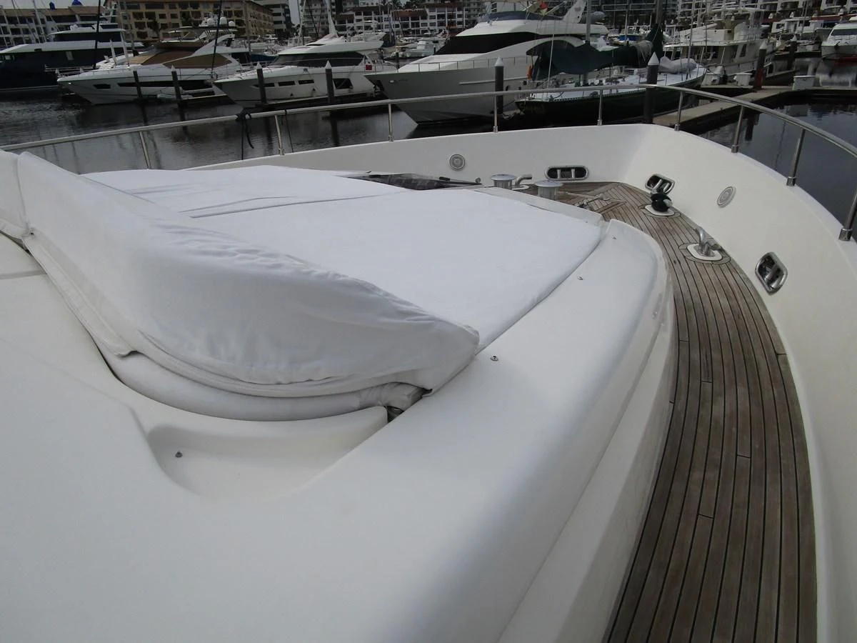a large white boat in a harbor aboard NACL Yacht for Sale