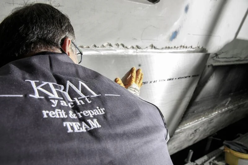 a person fixing a car aboard NEWAL Yacht for Sale