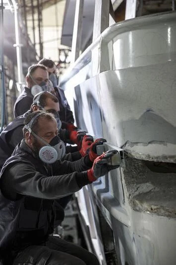 a group of people in a factory aboard NEWAL Yacht for Sale