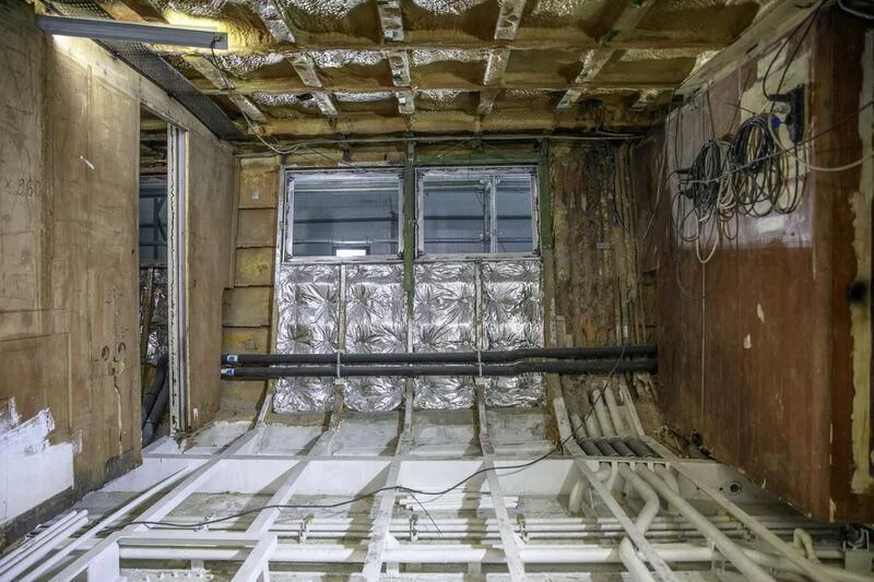 a room with a window and a ladder aboard NEWAL Yacht for Sale