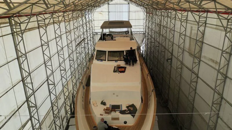 a large boat in a large building aboard NEWAL Yacht for Sale