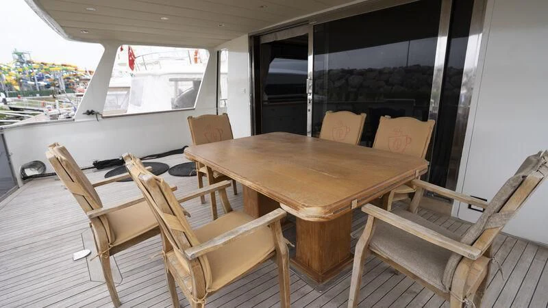 a table and chairs on a deck aboard NEWAL Yacht for Sale