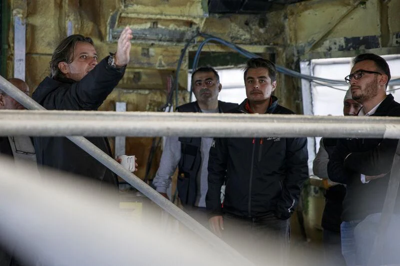 a group of men leaning on a railing aboard NEWAL Yacht for Sale