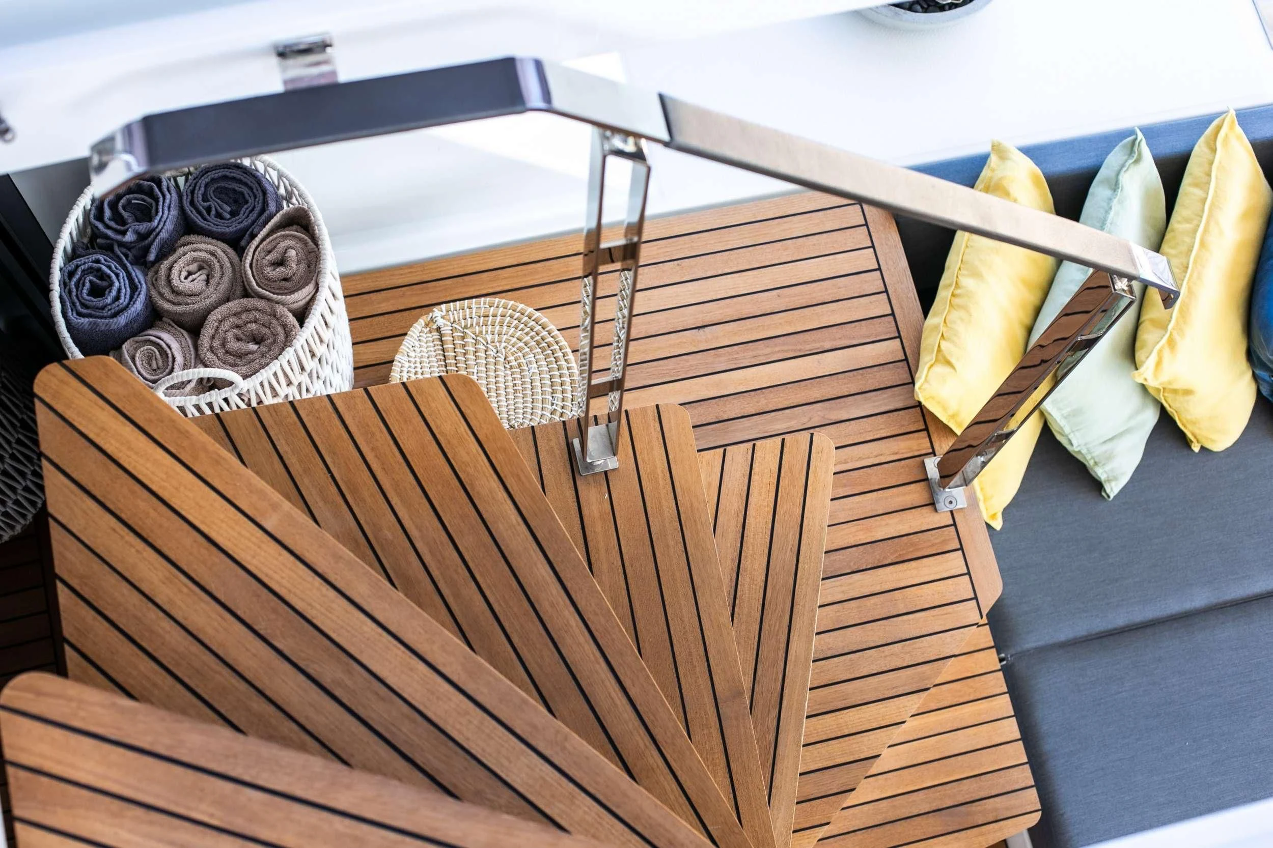 a wooden table with a basket and a basket on it aboard ALOIA Yacht for Charter