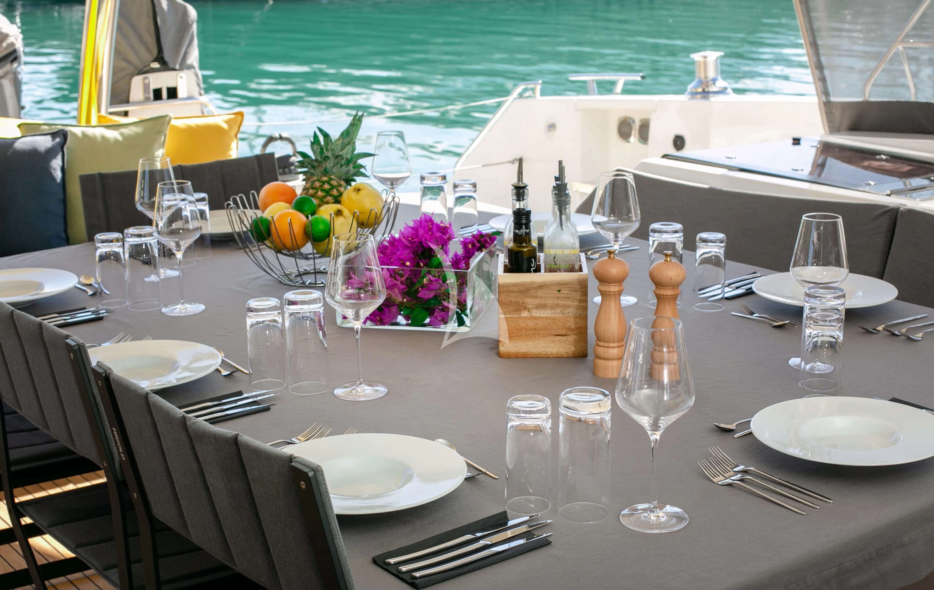 a table set for a dinner aboard ALOIA Yacht for Charter