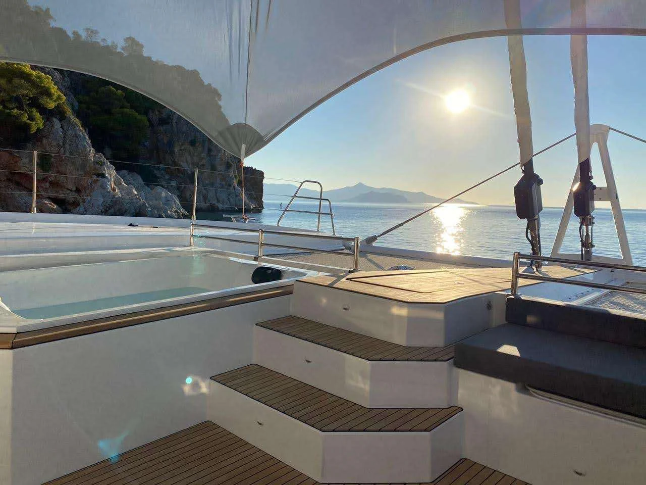 a couple of people standing on a boat in the water aboard ALOIA Yacht for Charter