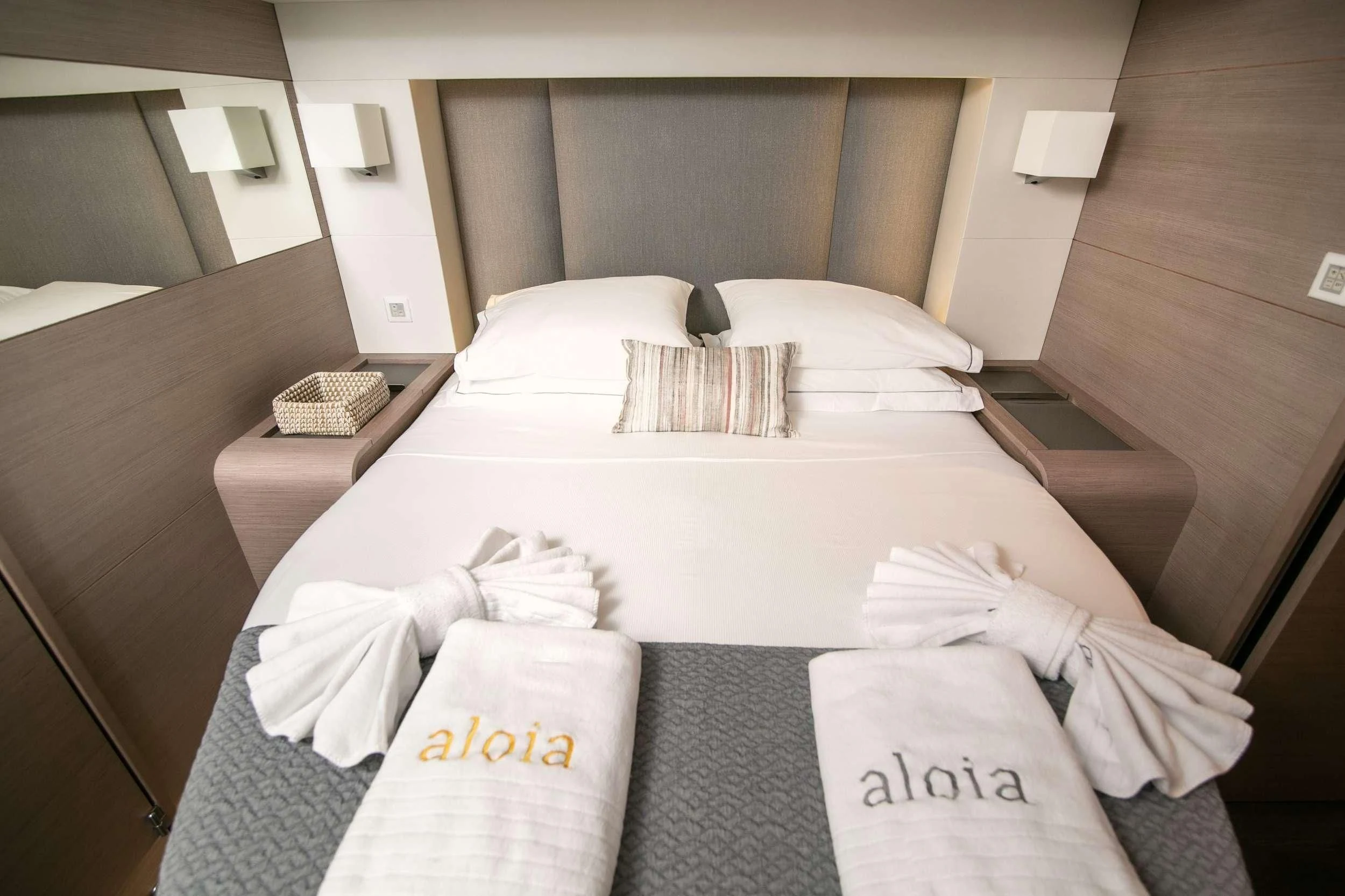a bed with pillows and pillows aboard ALOIA Yacht for Charter