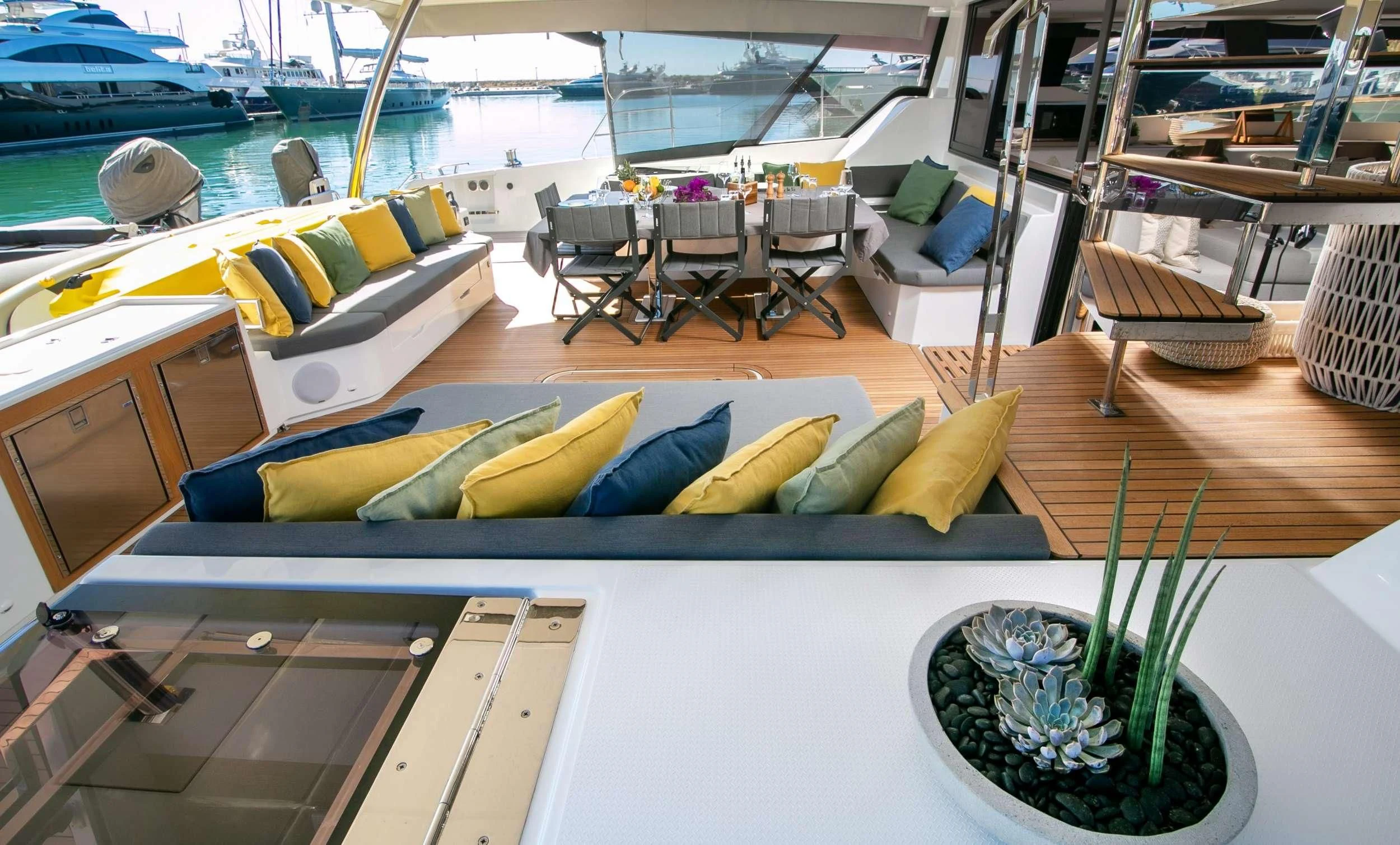 a table with chairs and a plant on it aboard ALOIA Yacht for Charter