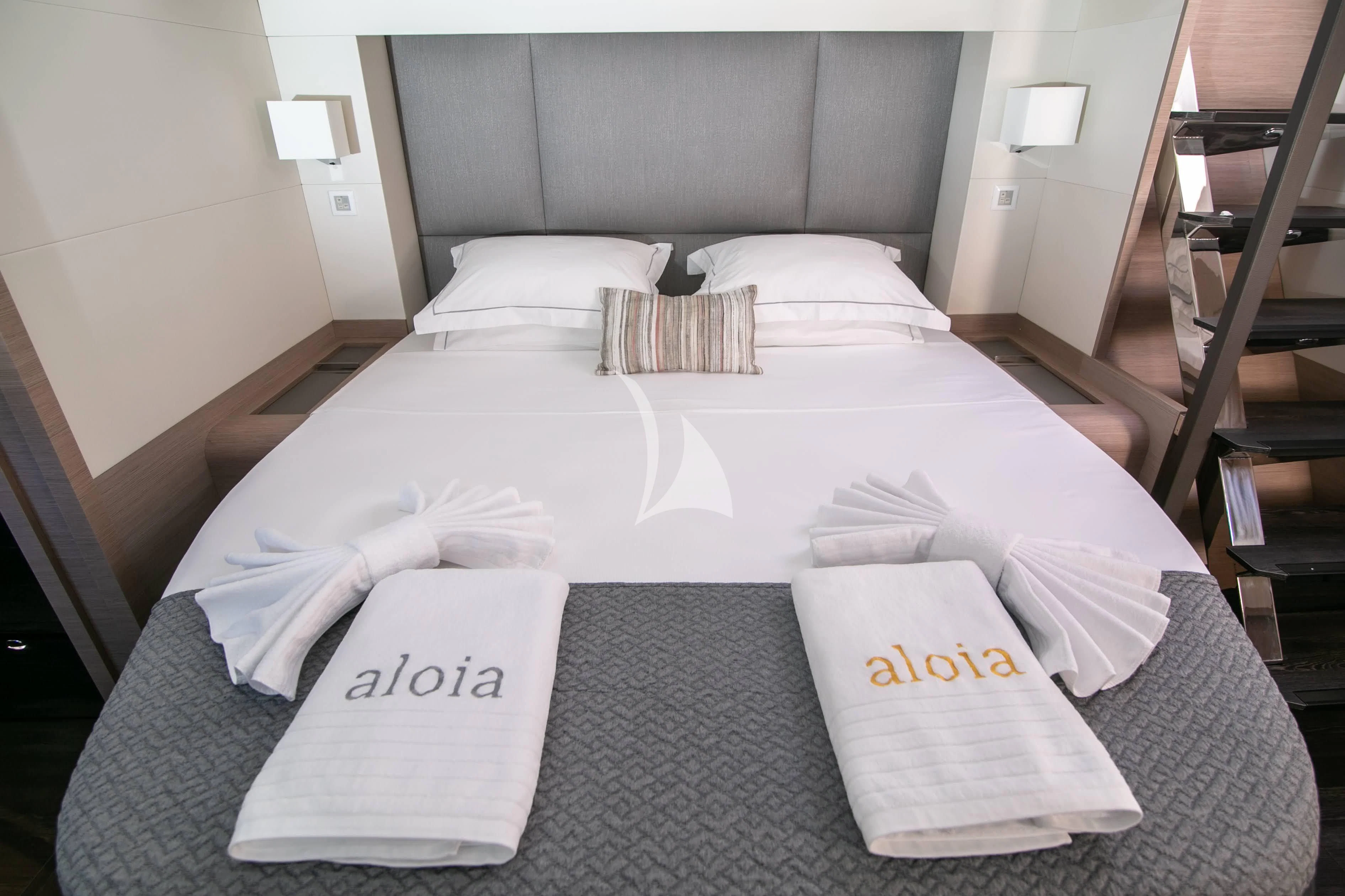 a bed with a white sheet and a white pillow aboard ALOIA Yacht for Charter
