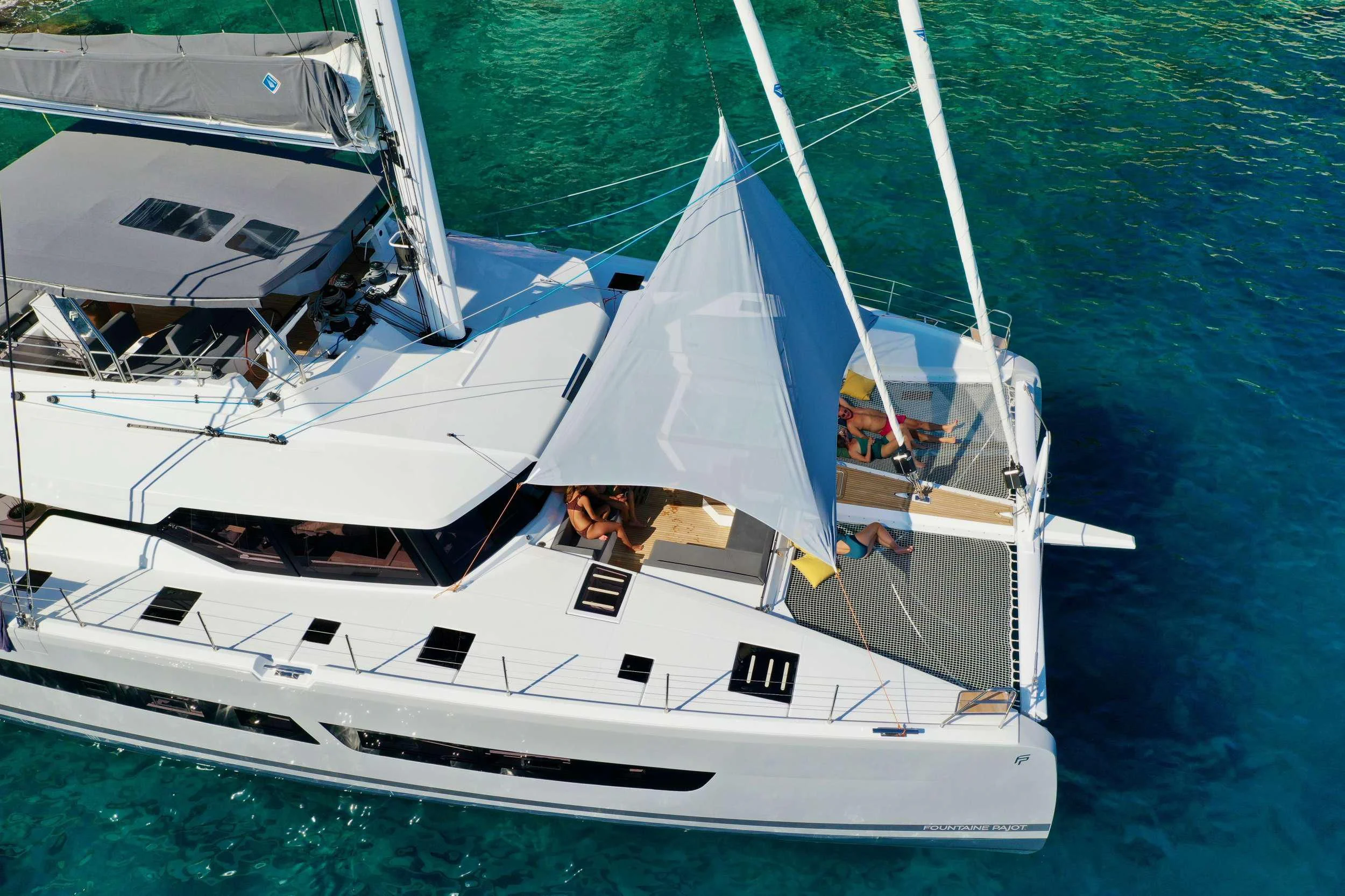 a couple of white boats on the water aboard ALOIA Yacht for Charter