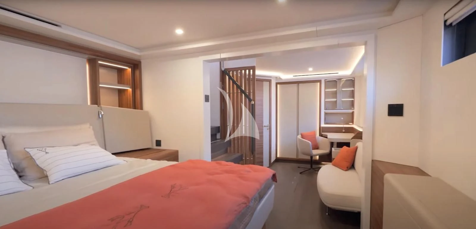 a bedroom with a bed and a desk aboard ALOIA Yacht for Charter