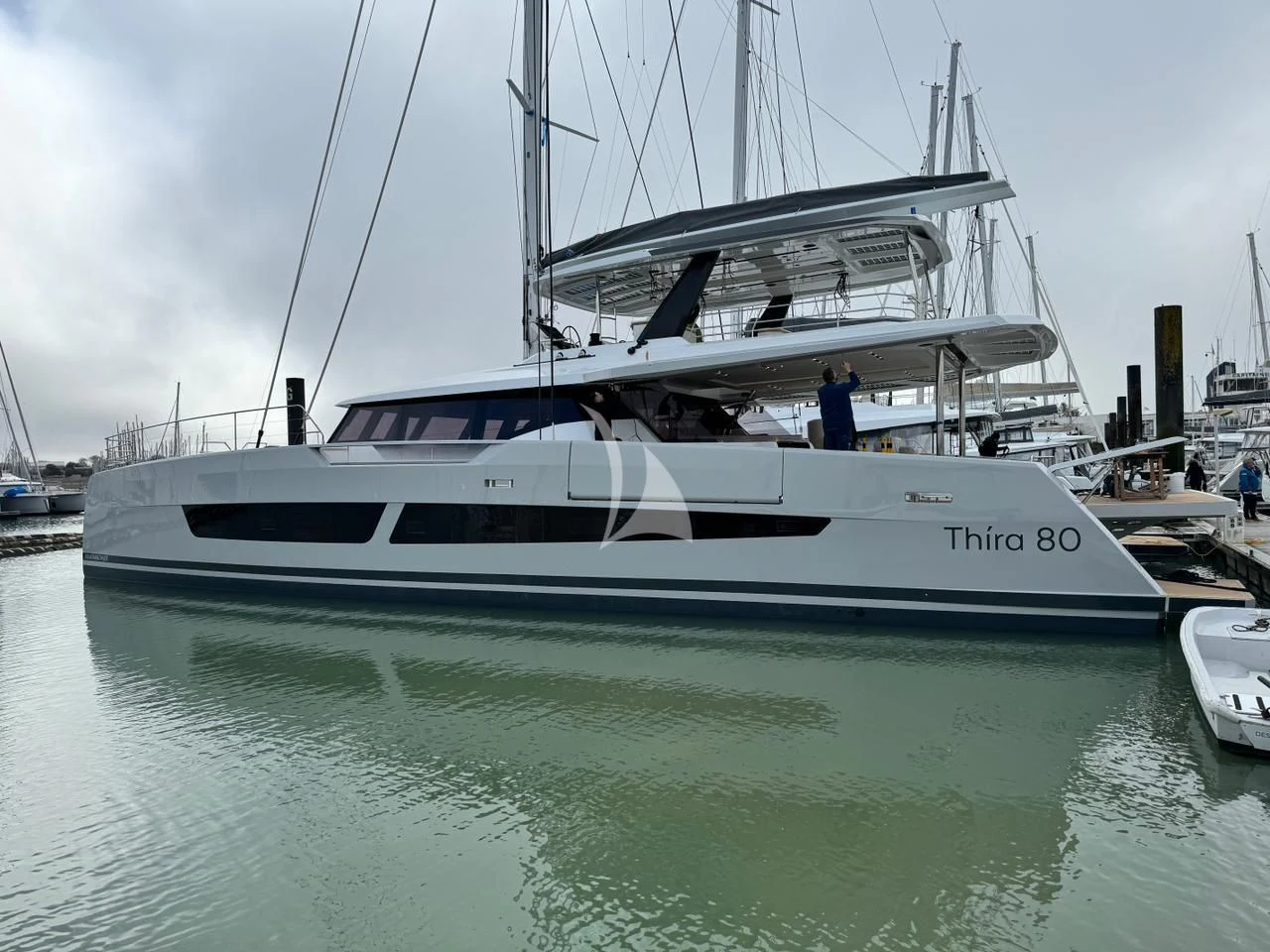 a white yacht in a harbor aboard ALOIA Yacht for Charter