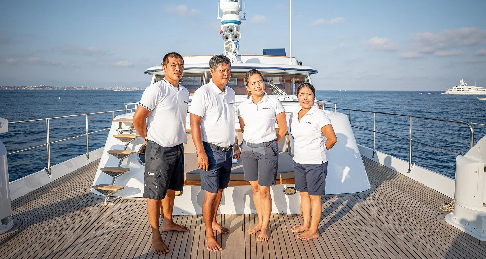 a group of people posing for a photo on a boat aboard CHANTELLA Yacht for Sale