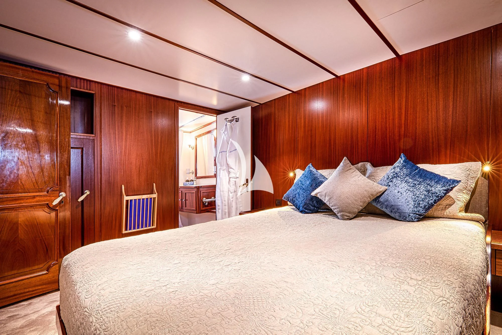 a bed with blue pillows aboard CHANTELLA Yacht for Sale